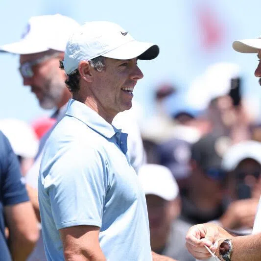 Rory McIlroy (left) and Tommy Fleetwood talk during a practice round for the US Open golf tournament.