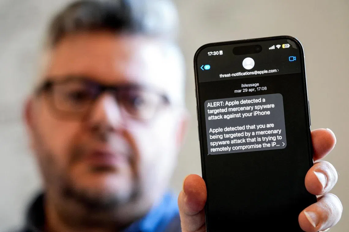 Italian investigative journalist Ciro Pellegrino shows his phone screen displaying a threat notification from Apple warning of a mercenary spyware attack, in Naples, Italy, June 11, 2025. REUTERS/Matteo Ciambelli