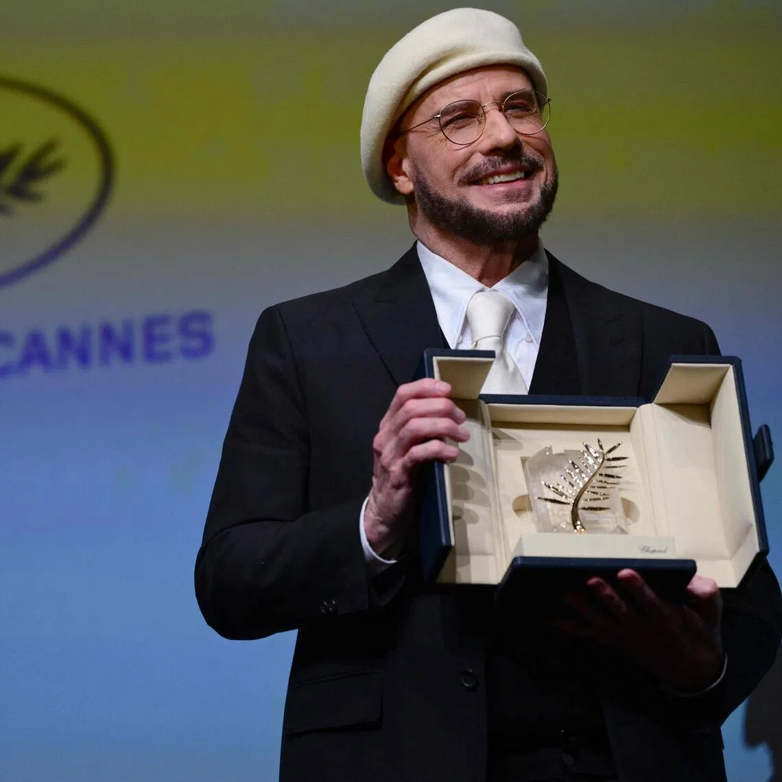 John Travolta receives an honorary Palm d'Or award prior to the screening of his film Propeller One-Way Night Coach at the Cannes Film Festival in Cannes, France on May 15.