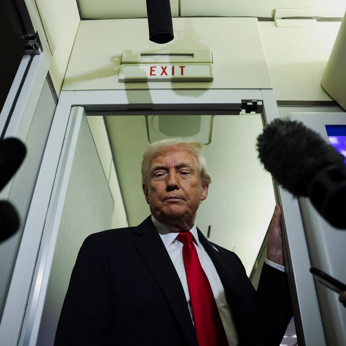U.S. President Donald Trump looks on as he speaks to reporters aboard Air Force One during travel to Palm Beach, Florida, from Joint Base Andrews, Maryland, U.S., November 25, 2025. REUTERS/Anna Rose Layden