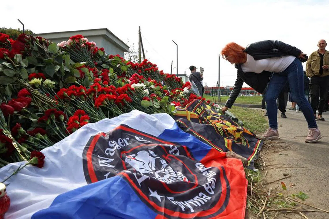 A woman visits a makeshift memorial near former PMC Wagner Centre, associated with the founder of the Wagner Group, Yevgeny Prigozhin, in Saint Petersburg, Russia August 24, 2023.  REUTERS/Anastasia Barashkova