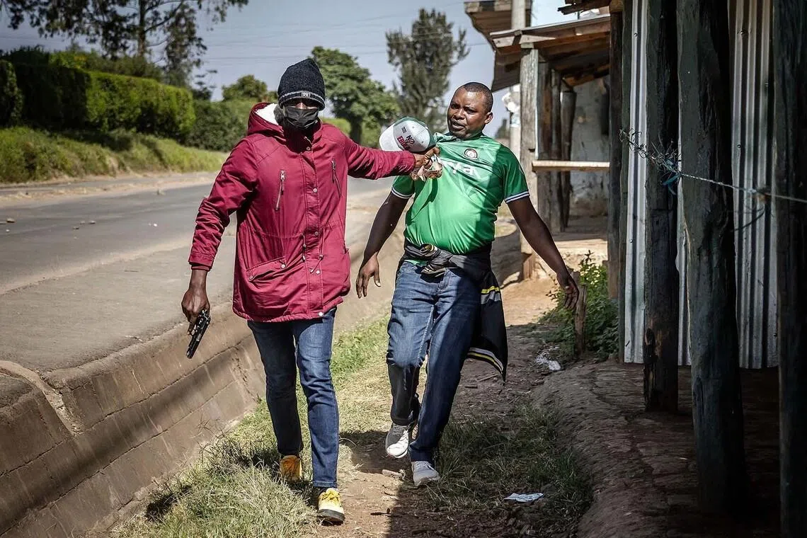 A protester being arrested by a plainclothes Kenyan police officer during a demonstration against a controversial US-built Ebola quarantine centre slated to begin operations at Laikipia Air Base in Nanyuki, Kenya, on June 9.