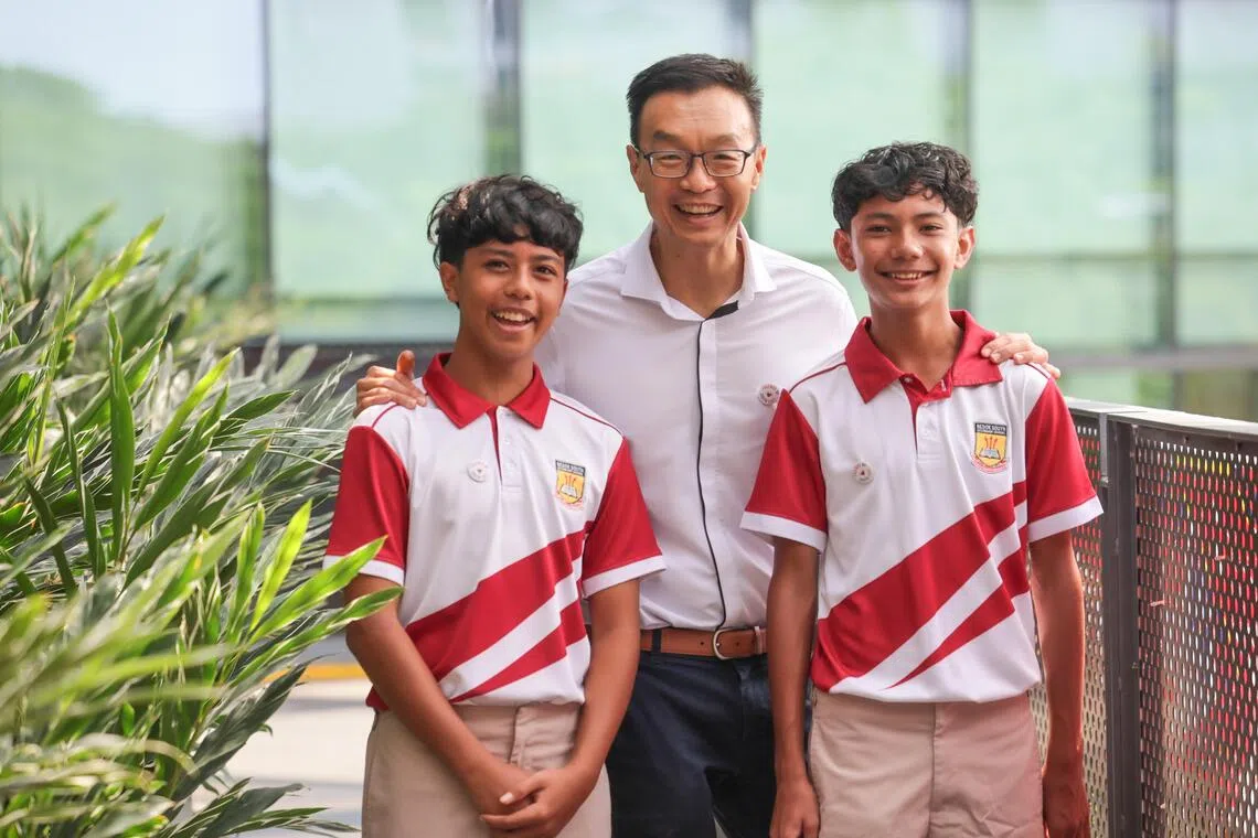 Bedok South Secondary School principal Daryl Koh with Secondary 2 student Raul Bin Rohaizat (left) and Secondary 1 student Azraf Rayyan Risdian.