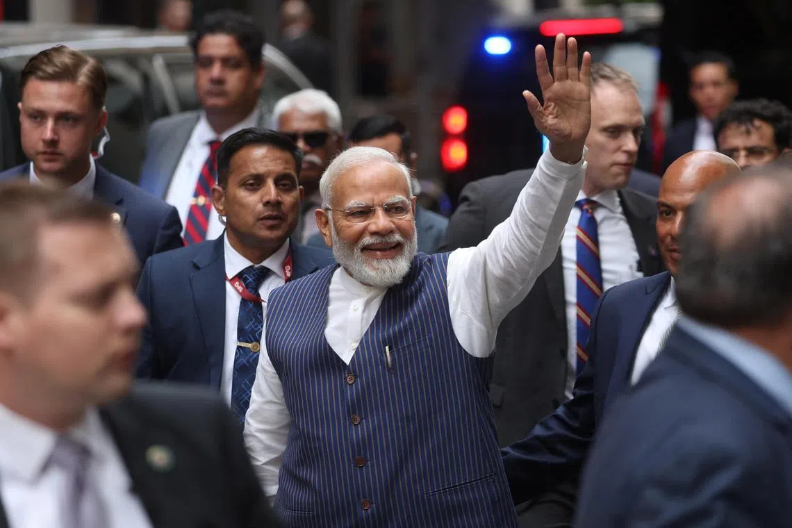Indian Prime Minister Narendra Modi waves to supporters as he arrives at the Lotte hotel in New York City.
