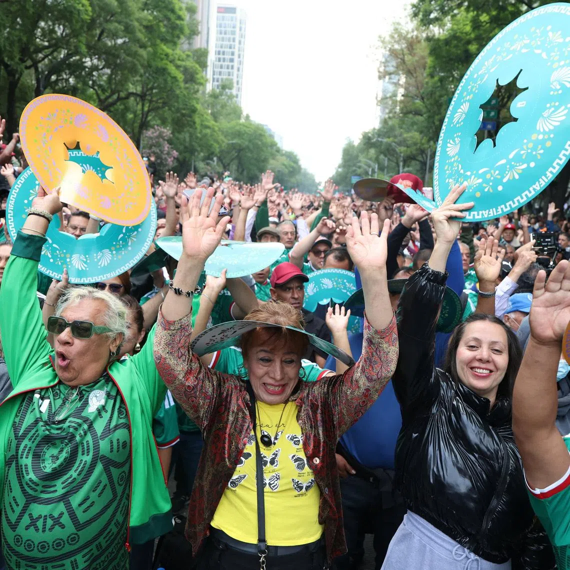 People participate in an attempt to break the Guinness World Record for the world’s largest “Mexican wave” along Reforma Avenue as part of activities ahead of the FIFA World Cup 2026, in Mexico City, Mexico, June 6, 2026. REUTERS/Luis Cortes