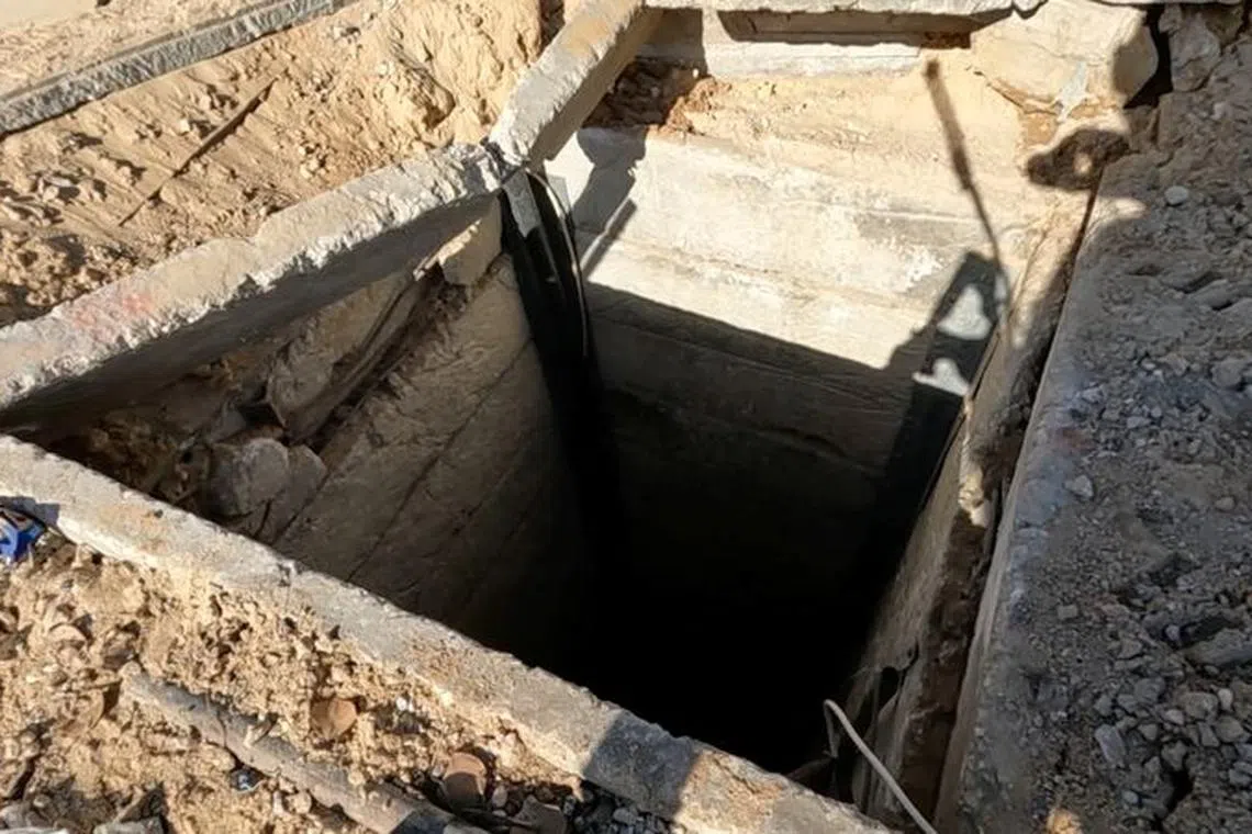 An Israeli soldier shows located Hamas tunnel shaft near the school, during the ongoing ground operation of the Israeli army against Palestinian Islamist group Hamas, in a location given as Beit Lahiya, in Gaza, in this handout still image obtained from a video released on December 2, 2023. Israel Defense Forces/Handout via REUTERS/ File Photo