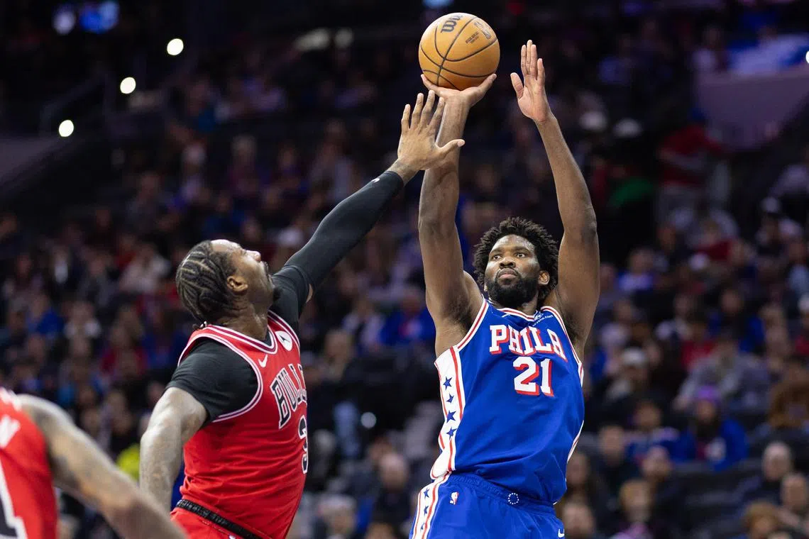 Philadelphia 76ers centre Joel Embiid (No. 21) shooting the ball past Chicago Bulls' Andre Drummond during the second quarter at Wells Fargo Centre.