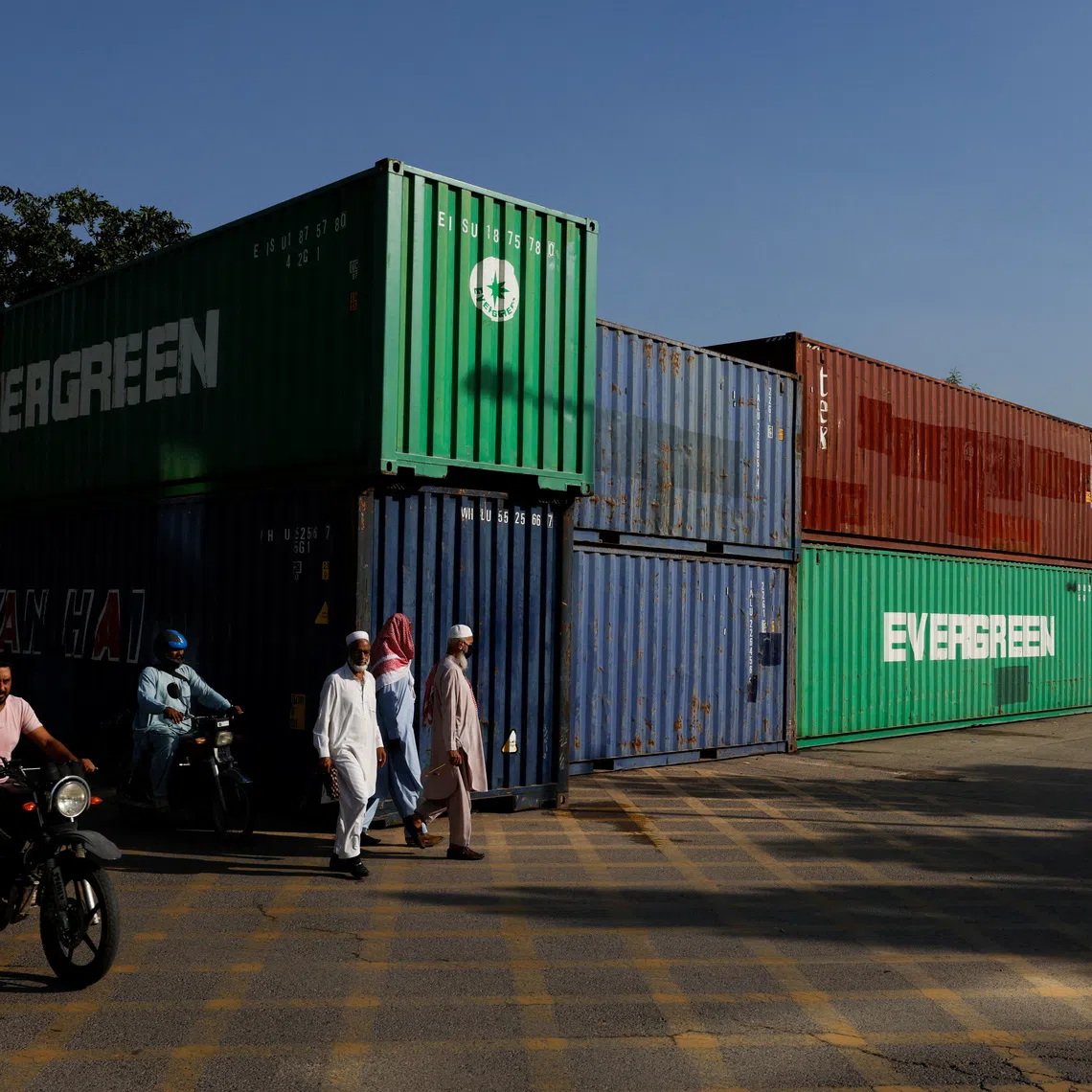 Steel shipping containers, packed with sand and welded together, have lined the roads into Islamabad for weeks, in preparations against a march to demand Khan’s release from prison.