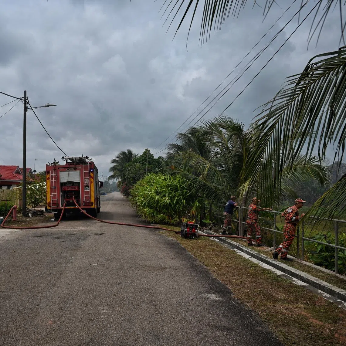Firefighters working to snuff out a peat fire in Pengerang, Johor, on Jan 28.