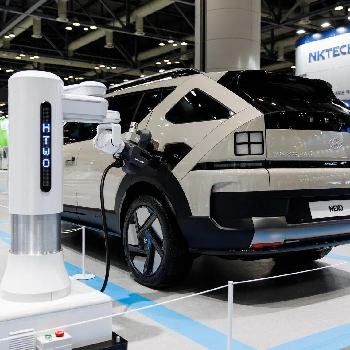A hydrogen charging robot charging an electric vehicle at the World Hydrogen Expo on Dec 4, in South Korea.