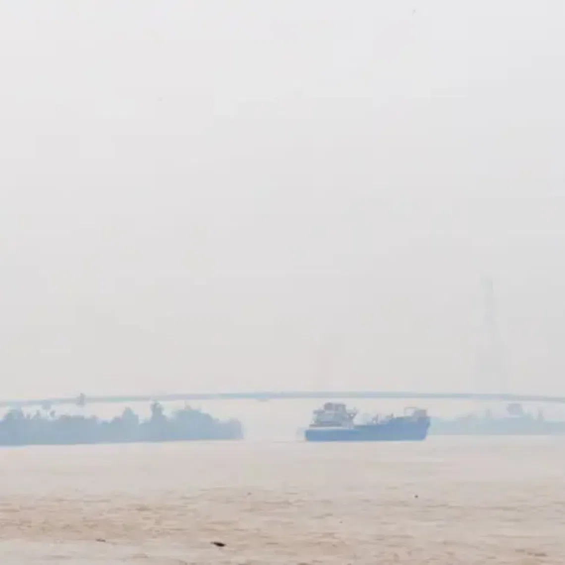 A vessel passes beneath the Batang Lupar II Bridge in Sri Aman, which recorded an API reading of 214, on Aug 30.