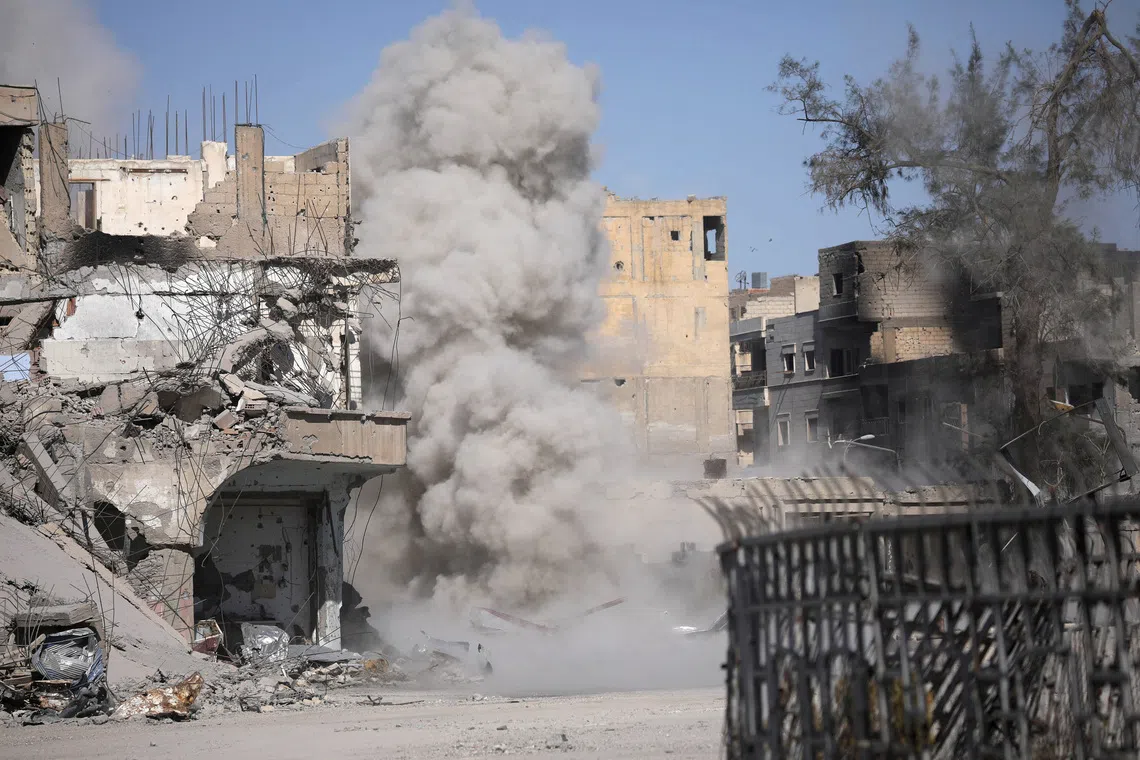 Smoke rises after a landmine exploded as fighters of Syrian Democratic Forces are clearing roads after liberation of Raqqa, Syria October 18, 2017.      REUTERS/Rodi Said