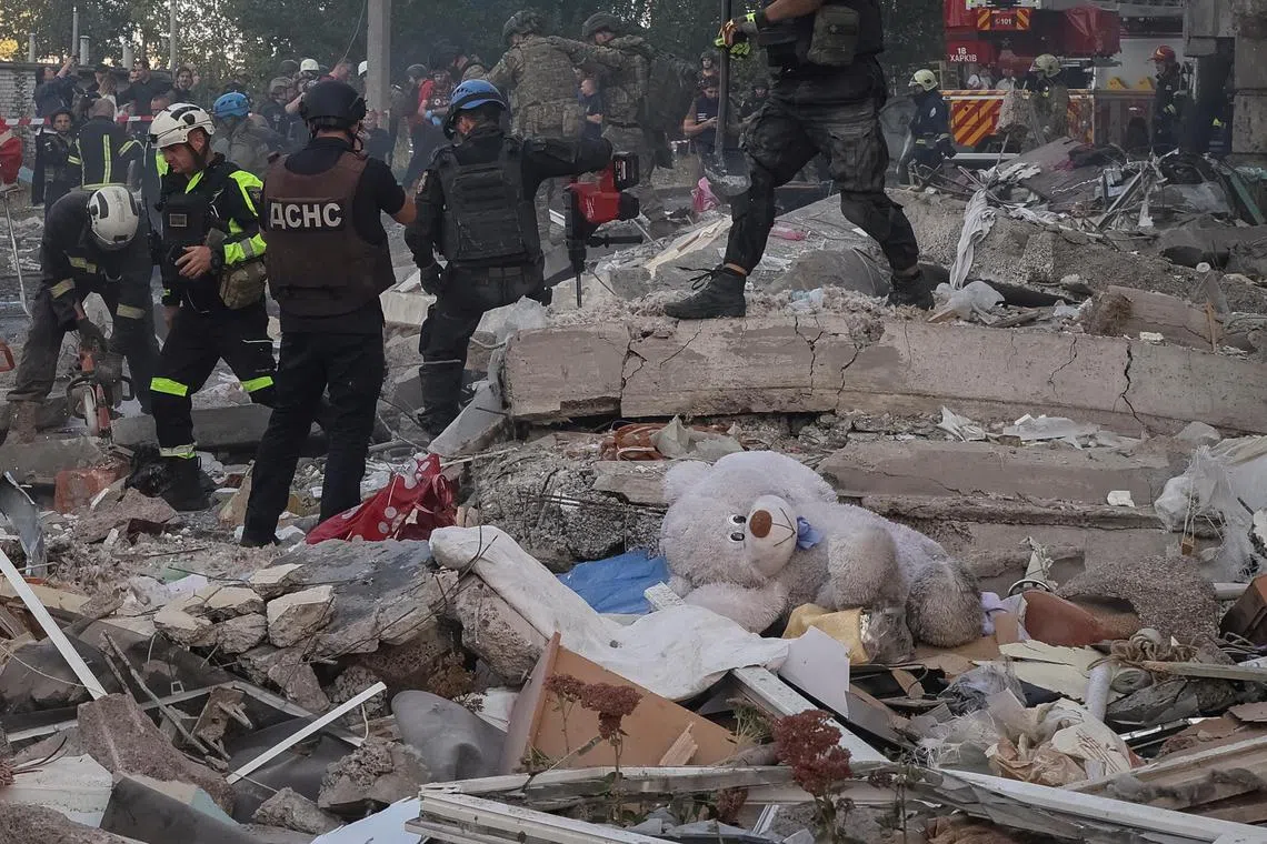 Rescuers working at an apartment building hit by a Russian air strike in Kharkiv, on Sept 24.