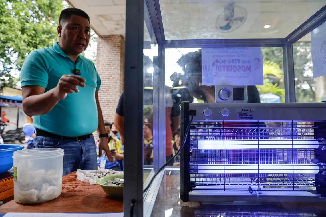 A Manila district uses a a glass-enclosed UV light machine to kill mosquitoes captured during an anti-dengue drive.