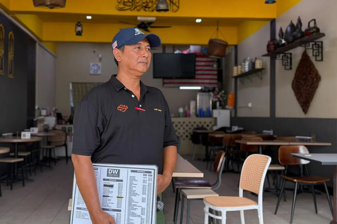 Chef Teddy at his empty cafe in Puncak Jalil, Selangor, where business is down 30 per cent as severe haze keeps diners away.