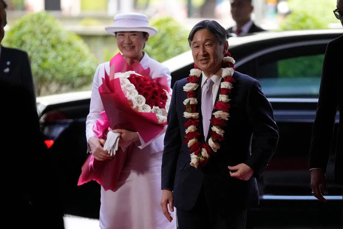 Japan's Emperor Naruhito (right) and Empress Masako arrive in Jakarta for their first state visit on June 17.