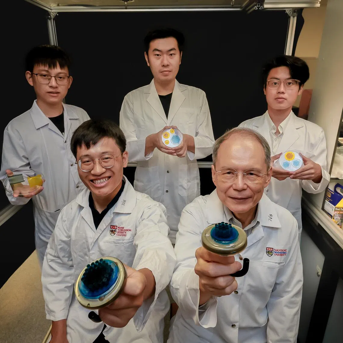 From left: 
Research Fellow Dr Liu Yangchengyi, Research Fellow Dr Linghu Changhong, PhD student Mr Huo Yucheng, Professor K Jimmy Hsia, President's Chair in Mechanical Engineering, and Undergraduate Mr Jiang Haoyu holding the Shape Memory Polymer (SMP) Adhesive Fibril Arrays at NTU on April 29, 2024.