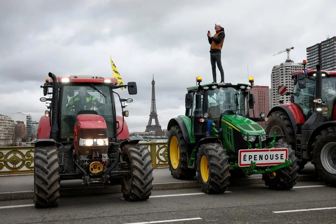 FILE PHOTO: French farmers of the Coordination Rural (CR) use their tractors during a go-slow operation on the Pont Mirabeau bridge with the Eiffel Tower in the background as they protest ahead of the opening of the Paris farm show, in Paris, France, February 23, 2024. REUTERS/Benoit Tessier/File Photo