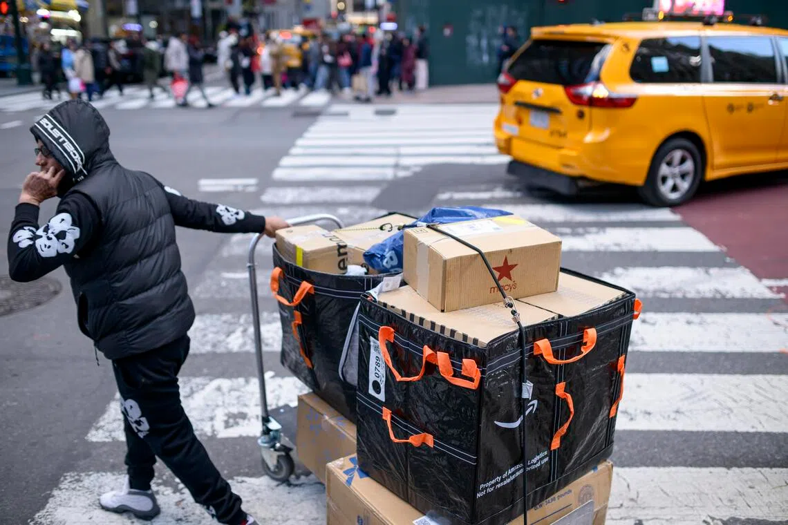 An Amazon logistics delivery person navigates 5th Avenue on Black Friday in Manhattan, on Nov 28. 