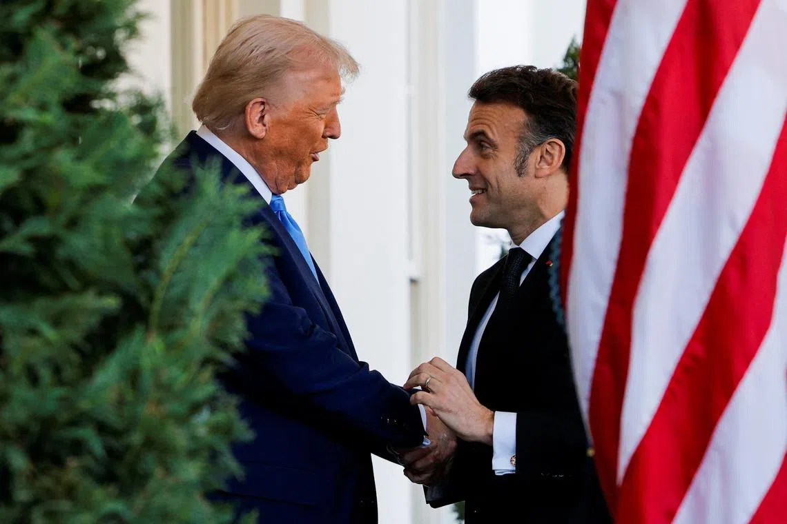 U.S. President Donald Trump shakes hands with French President Emmanuel Macron at the White House in Washington, D.C., U.S., February 24, 2025. REUTERS/Brian Snyder
