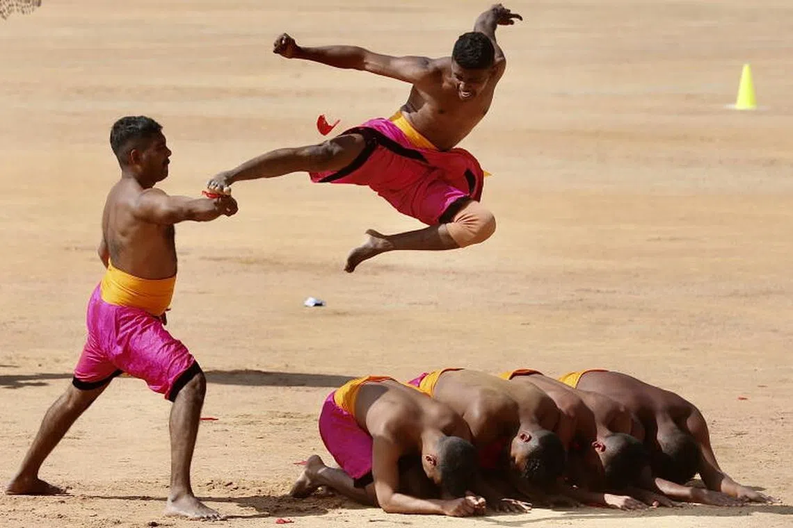 Students show their martial arts skills during a cultural event within the Republic Day celebrations in Bangalore, India. The 'Republic Day of India' marks the date on which the Constitution of India came into force on 26 January 1950 and usually include various parades including shows of military equipment and cultural displays.  PHOTO : EPA-EFE