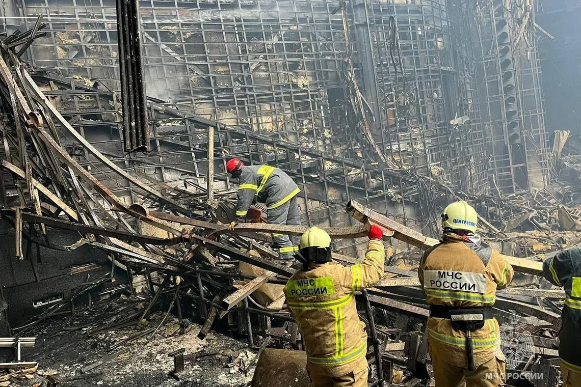 Members of the Russian Emergencies Ministry clear rubble at the Crocus City Hall concert venue after a deadly attack, outside Moscow, Russia, March 23, 2024. Russian Emergencies Ministry/Handout via REUTERS