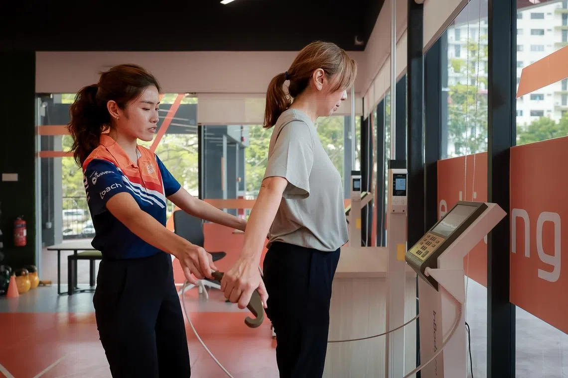Active Health coach Mavis Lo, 27, helping The Straits Times Executive Editor Sumiko Tan with her body composition analysis at the Active Health Lab at Delta Sports Complex on Oct 2, 2024.