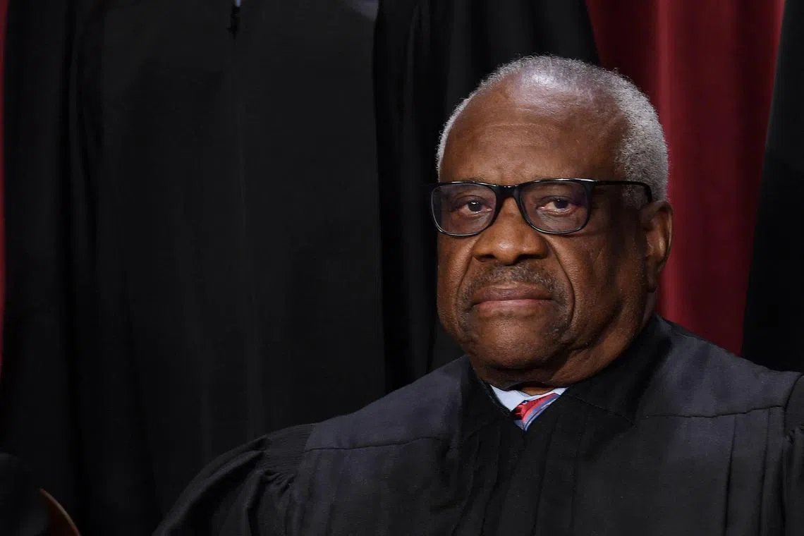 (FILES) In this file photo taken on October 7, 2022 US Supreme Court Justice Clarence Thomas poses for the official photo at the Supreme Court in Washington, DC. - Thomas defended himself on April 7, 2023 over accusations that he accepted years of luxury travel trips from a Republican billionaire, saying that it was "personal hospitality" that did not need to be registered. Staunch conservative Thomas was a guest of megadonor Harlan Crow for yachting in New Zealand, private jet flights across the globe and regular stays at Crow's properties in the United States, the ProPublica news outlet reported. (Photo by OLIVIER DOULIERY / AFP)