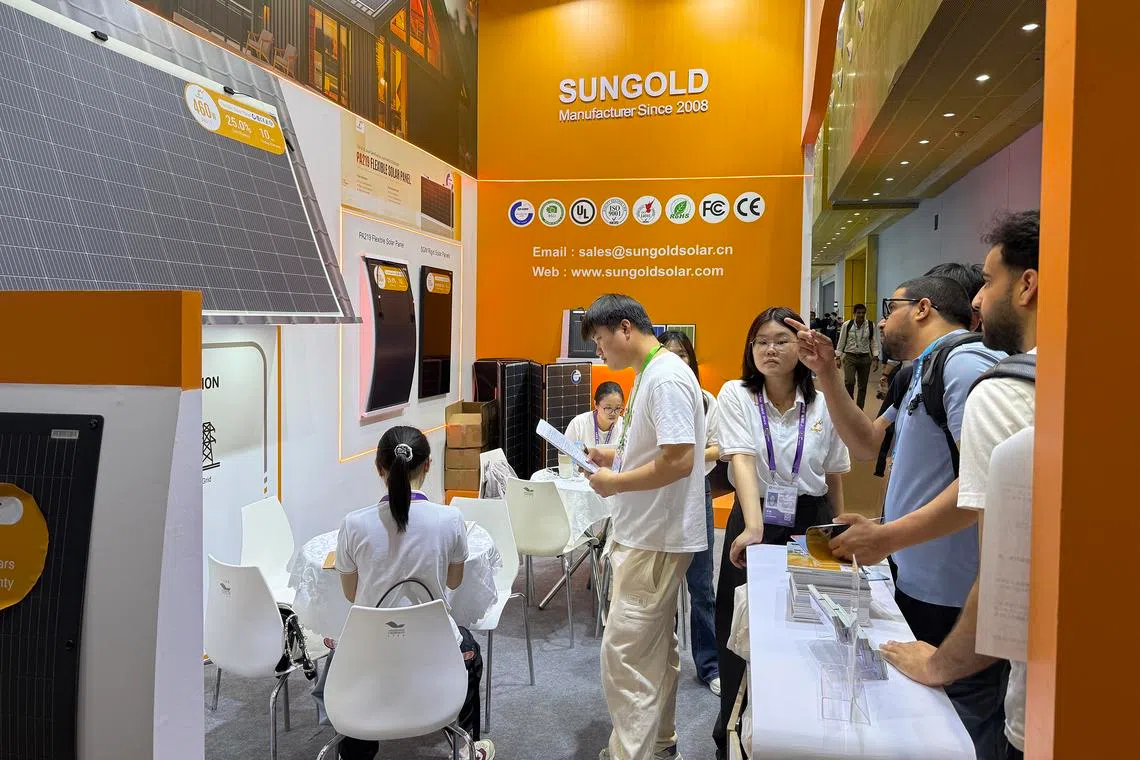 Visitors looking at solar panels at the Canton Fair in Guangzhou on April 15.