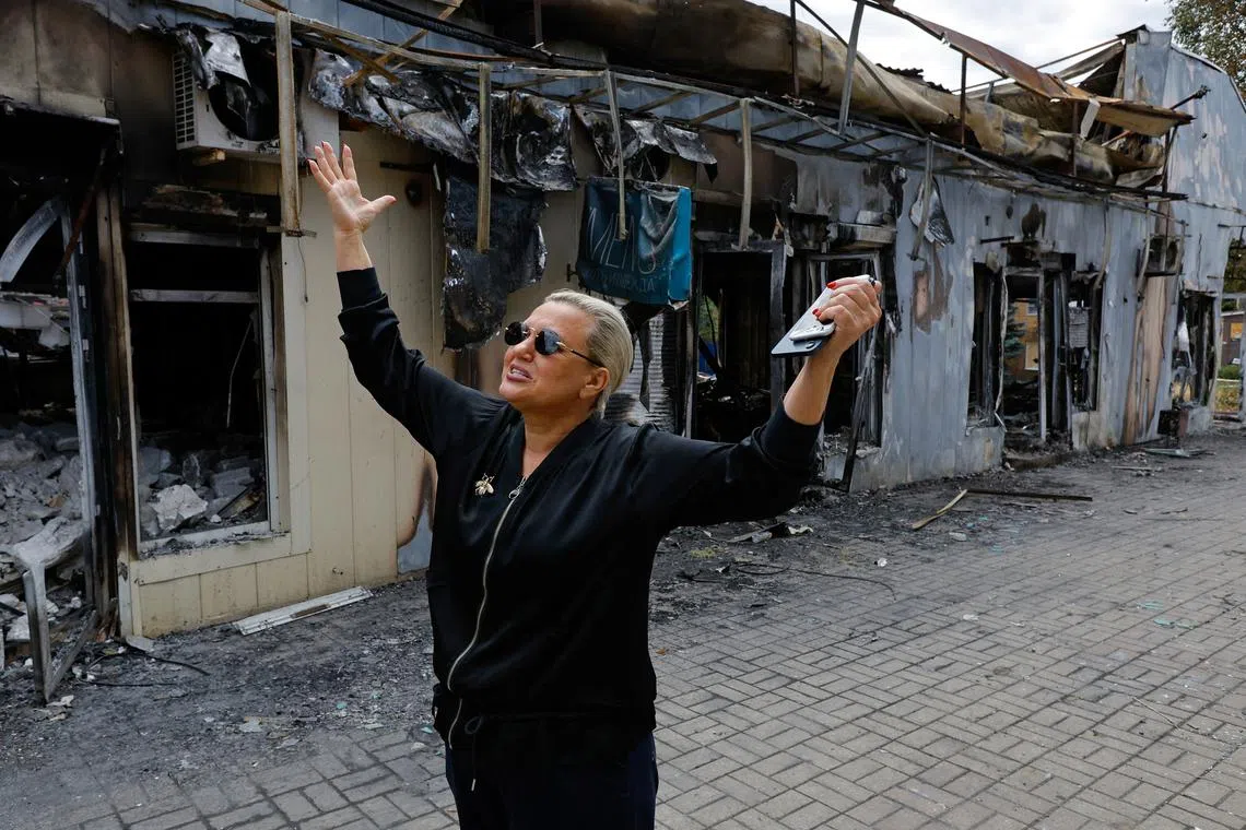 Shop owner Tamara Pozdnyakova, 58, speaks in front of the shops damaged by shelling of the market on 30 June in what local Russian-installed authorities called a Ukrainian military strike, in the course of Russia-Ukraine conflict in Donetsk, a Russian-controlled city of Ukraine, July 3, 2025. REUTERS/Alexander Ermochenko