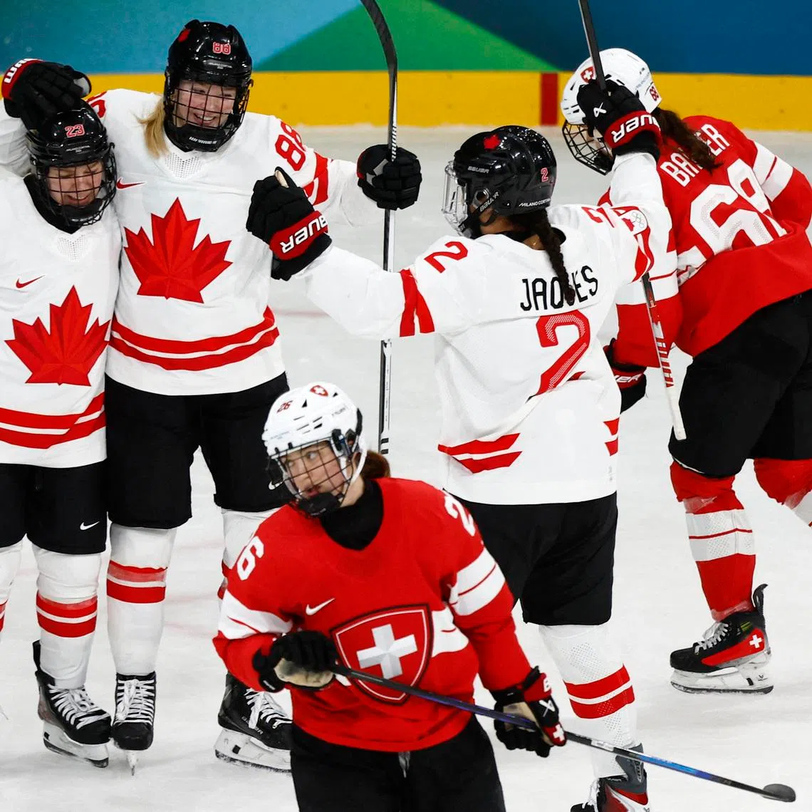 Milano Cortina 2026 Olympics - Ice Hockey - Women's Preliminary Round - Group A - Switzerland vs Canada - Milano Rho Ice Hockey Arena, Milan, Italy - February 07, 2026. Julia Gosling of Canada celebrates scoring their third goal against Switzerland with Sophie Jaques of Canada and Erin Ambrose of Canada REUTERS/Alessandro Garofalo