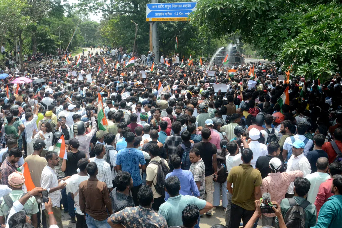 Demonstrators march on the state legislature as police use water cannons to disperse them during a protest against alleged irregularities in the state's civil services examinations, in Ranchi, India, August 10, 2026. REUTERS/Stringer