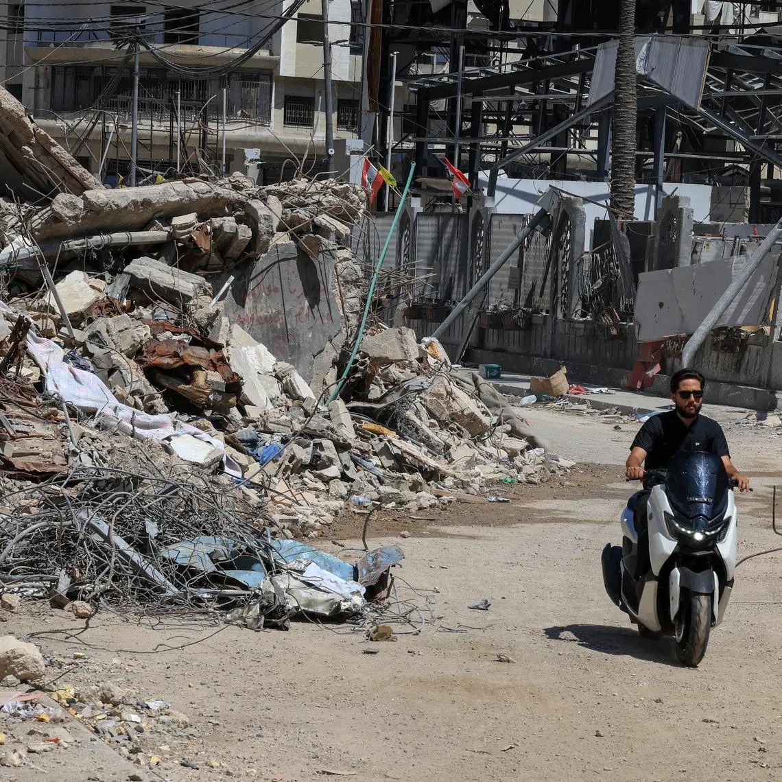FILE PHOTO: A man rides past the rubble of buildings damaged in Israeli strikes in Beirut’s southern suburbs in Beirut, Lebanon, July 6, 2026. REUTERS/Mohamed Azakir
