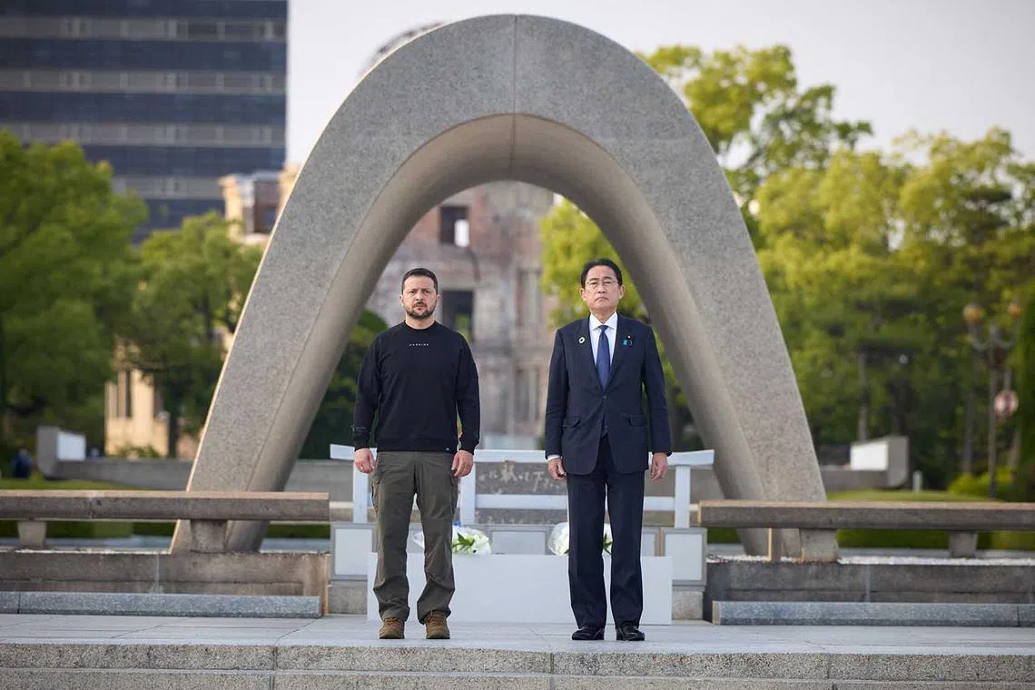 This handout photograph taken and released by the Ukrainian Presidential Press Service on May 21, 2023, shows Ukraine's President Volodymyr Zelensky (L) and Japan's Prime Minister Fumio Kishida (R) attending a wreath laying ceremony at the Hiroshima Peace Memorial Park, following the G7 Leaders' Summit in Hiroshima. (Photo by Handout / Ukrainian Presidential Press Service / AFP) / RESTRICTED TO EDITORIAL USE - MANDATORY CREDIT "AFP PHOTO /HANDOUT / UKRAINIAN PRESIDENTIAL PRESS SERVICE" - NO MARKETING NO ADVERTISING CAMPAIGNS - DISTRIBUTED AS A SERVICE TO CLIENTS