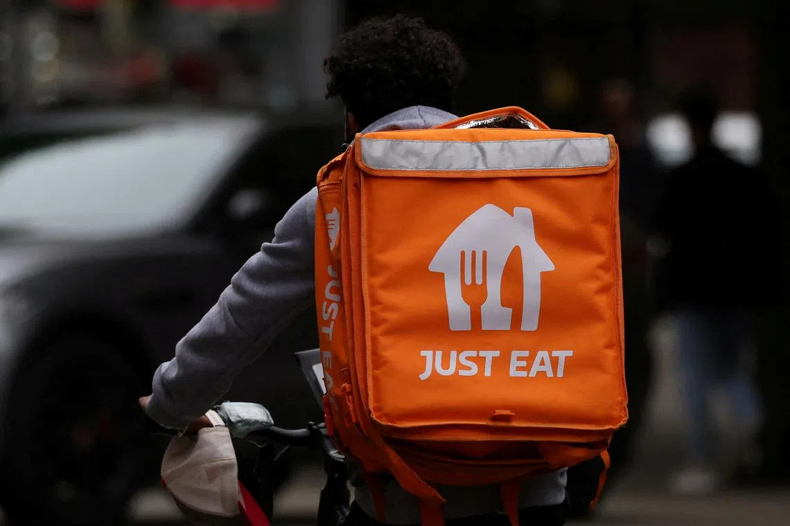FILE PHOTO: A Just Eat delivery rider cycles through Manchester, Britain, August 23, 2023. REUTERS/Phil Noble/File Photo