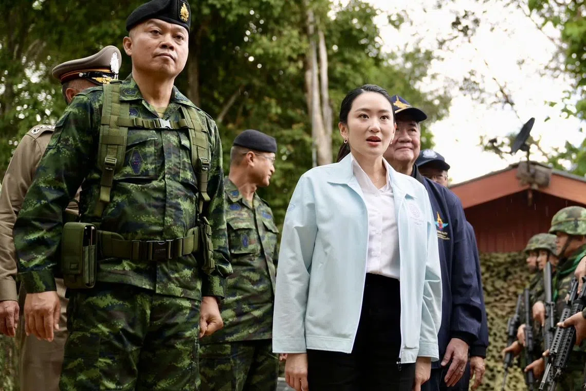 Thai PM Paetongtarn Shinawatra, accompanied by Lieutenant-General Boonsin Padklang, whom she had disparaged in a leaked phone call, visiting an army base near the Cambodian border on June 20.