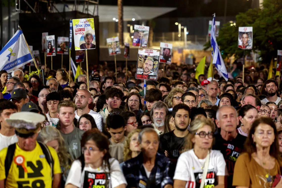Relatives and supporters of Israeli hostages held captive in the Gaza Strip hold their portraits during a protest at Hostages Square in Tel Aviv on May 28, 2025.