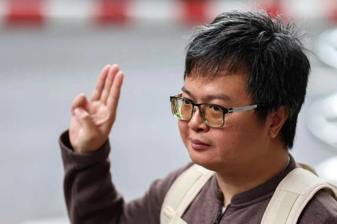 Arnon Nampa, a prominent activist and former human rights lawyer, flashes a three finger salute as he arrives ahead of a Thai criminal court's verdict in a case of allegedly having insulted the monarchy, at the criminal court in Bangkok, Thailand, September 26, 2023. REUTERS/Athit Perawongmetha/file photo