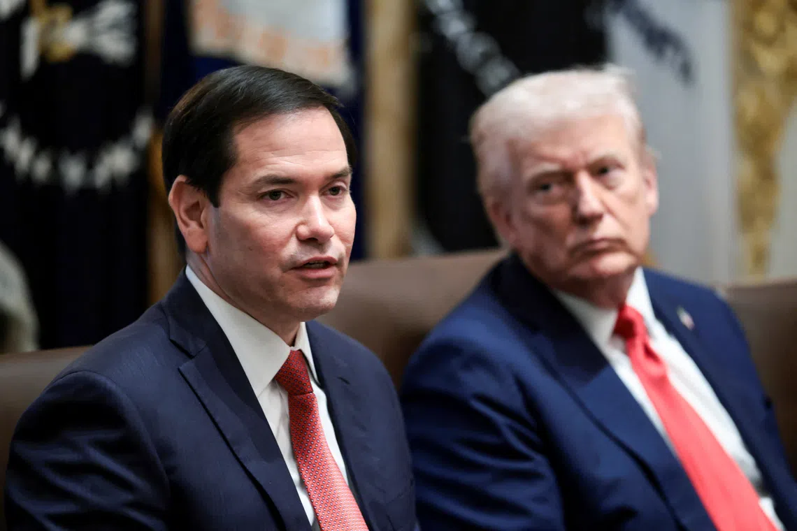 US President Donald Trump (right) listens as Secretary of State Marco Rubio speaks during a Cabinet meeting at the White House on Oct 9. 