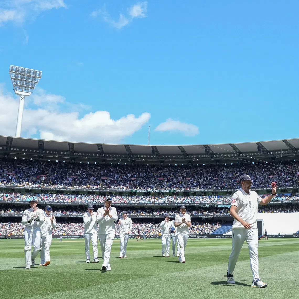 Cricket - The Ashes - Australia v England - Fourth Test -  MCG, Melbourne, Australia - December 26, 2025 England's Josh Tongue walks off the field raising the ball after claiming 5 wickets. REUTERS/Asanka Brendon Ratnayake