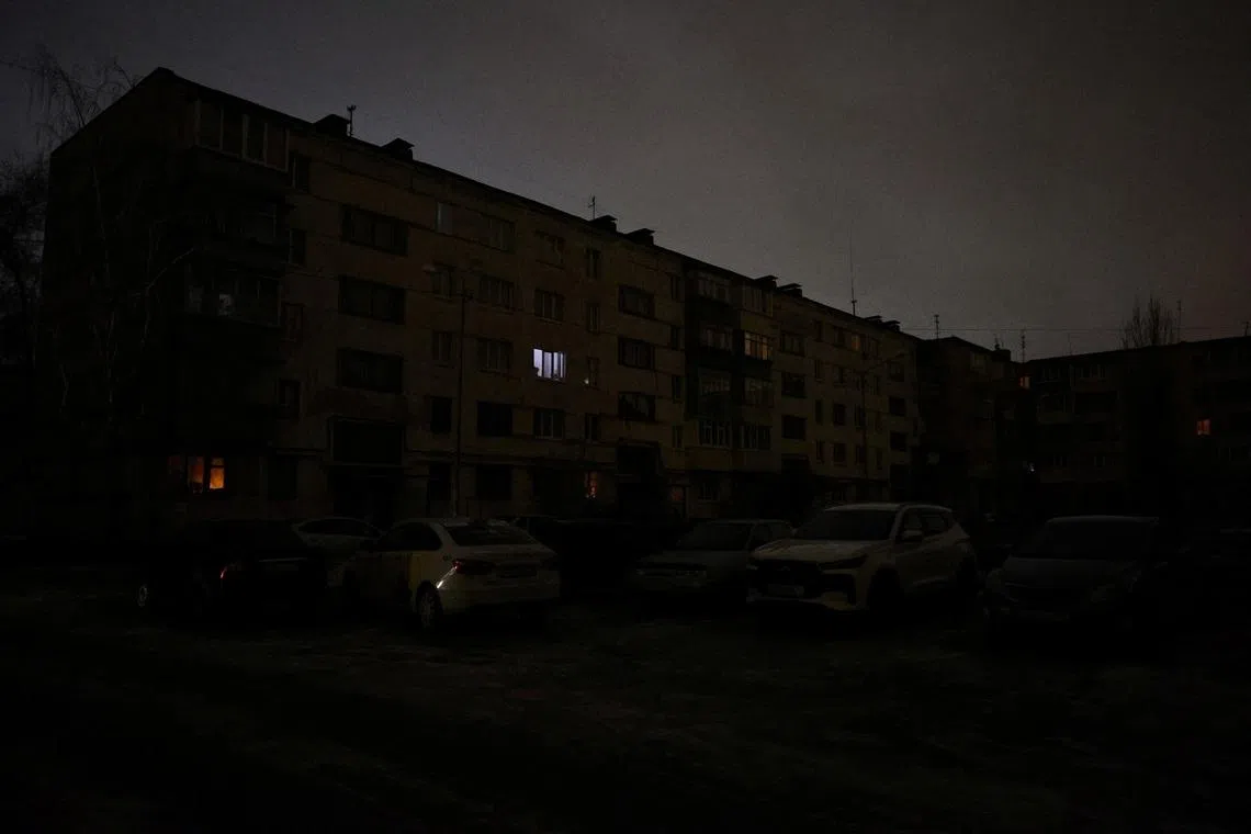 A residential building and cars during a power blackout, that according to local authorities was caused by a recent Ukrainian missile attack targeting the regional energy system, amid the Russia-Ukraine military conflict in Belgorod, Russia, January 9, 2026. REUTERS/Stringer