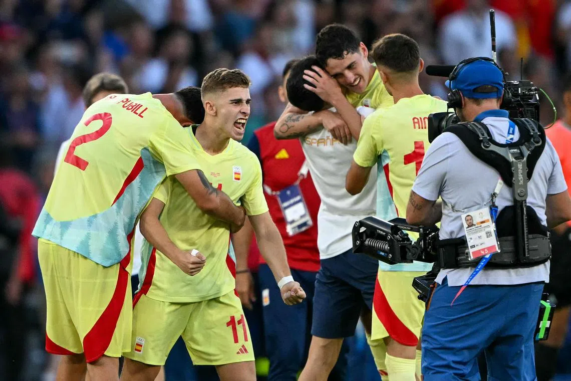 Spain's midfielder Fermin Lopez and teammates celebrating after winning the men's final against France on Aug 9.