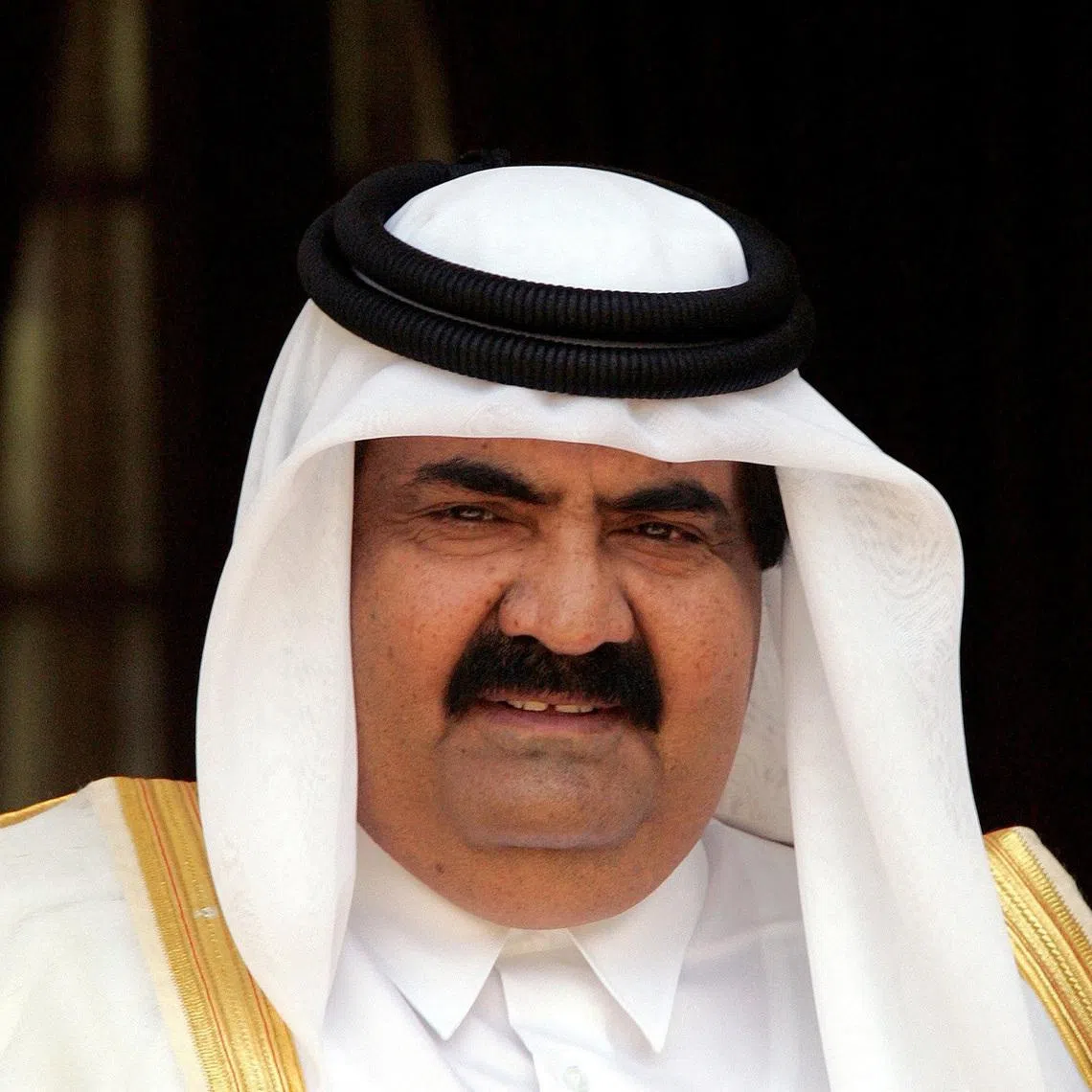 FILE PHOTO: The emir of Qatar, Sheikh Hamad bin Khalifa al-Thani, looks on before his meeting with Indian Prime Minster Manmohan Singh (not in picture) in New Delhi, India April 14, 2005. REUTERS/B Mathur/File Photo