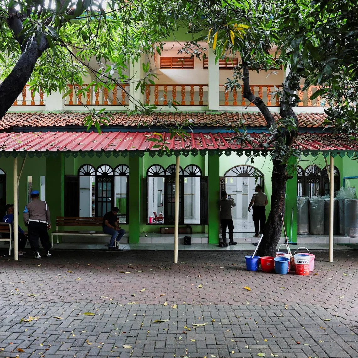 Police officers guard outside a mosque where explosions occurred the previous day, at a school complex in Jakarta on Nov 8, 2025.