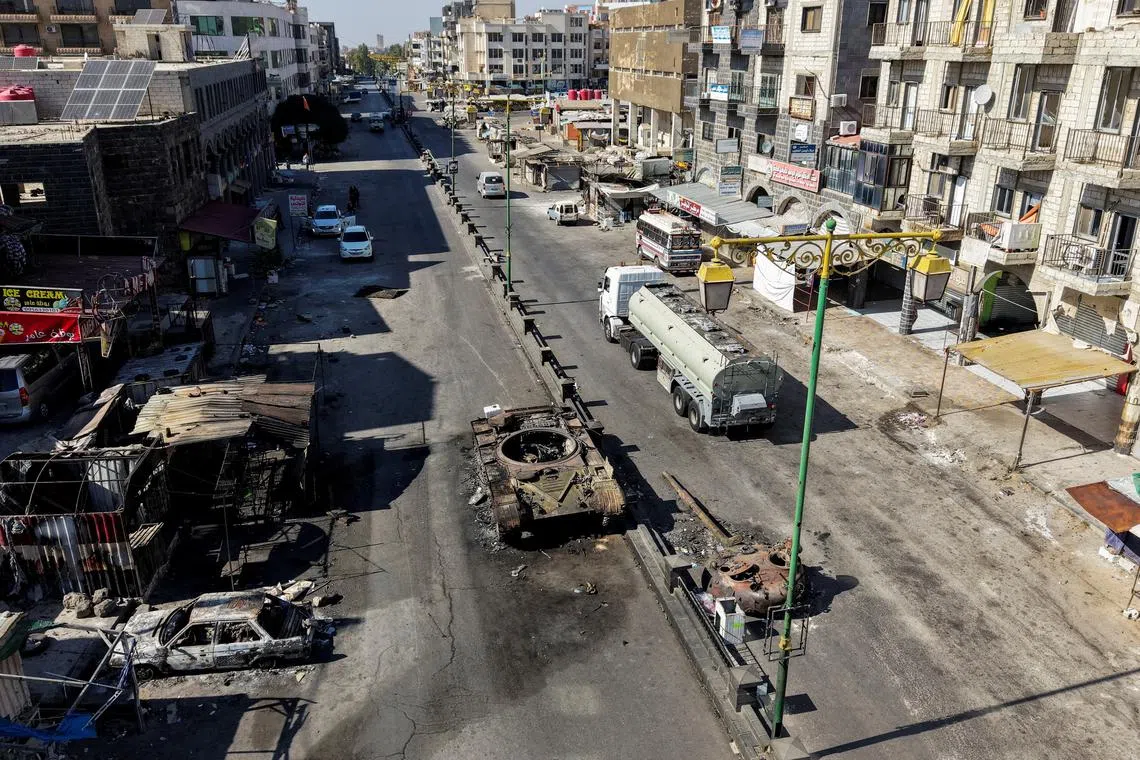 A drone view shows the remains of a destroyed tank, following deadly clashes between Druze fighters, Sunni Bedouin tribes and government forces, in Syria's predominantly Druze city of Sweida, Syria July 25, 2025. REUTERS/Khalil Ashawi/File Photo