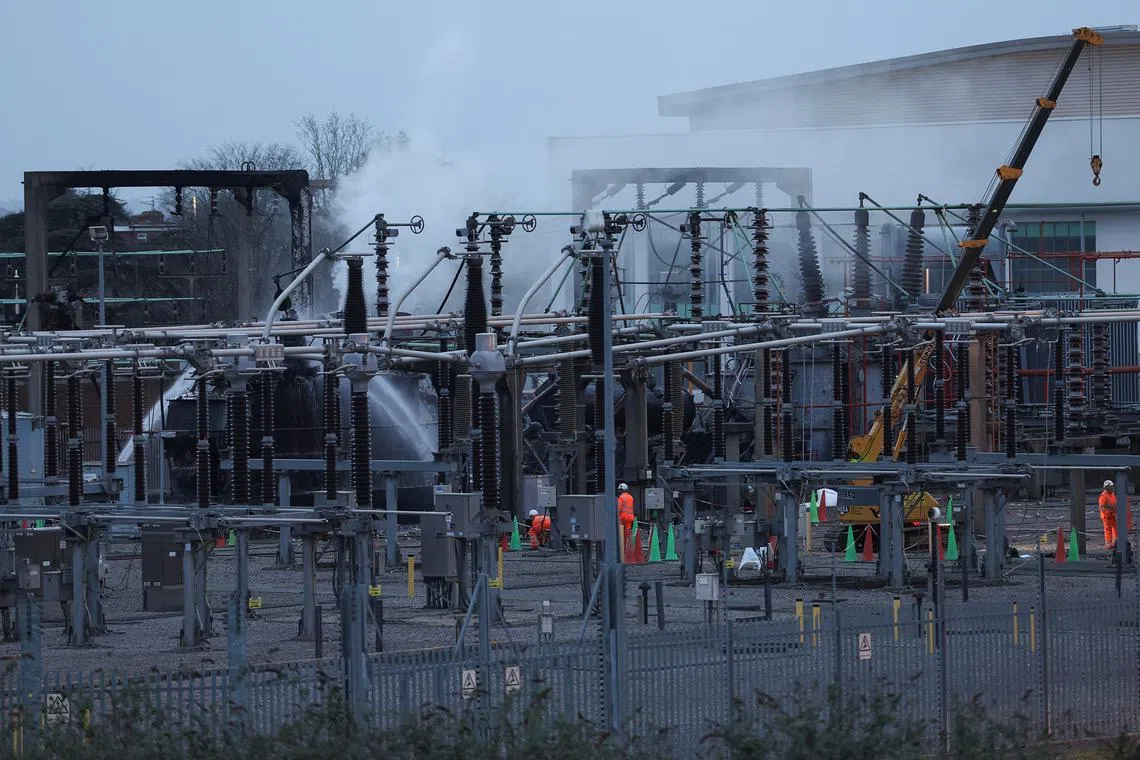 People work at an electrical substation, after a fire there wiped out the power at Heathrow International Airport, in Hayes, London, Britain, March 21, 2025. REUTERS/Isabel Infantes