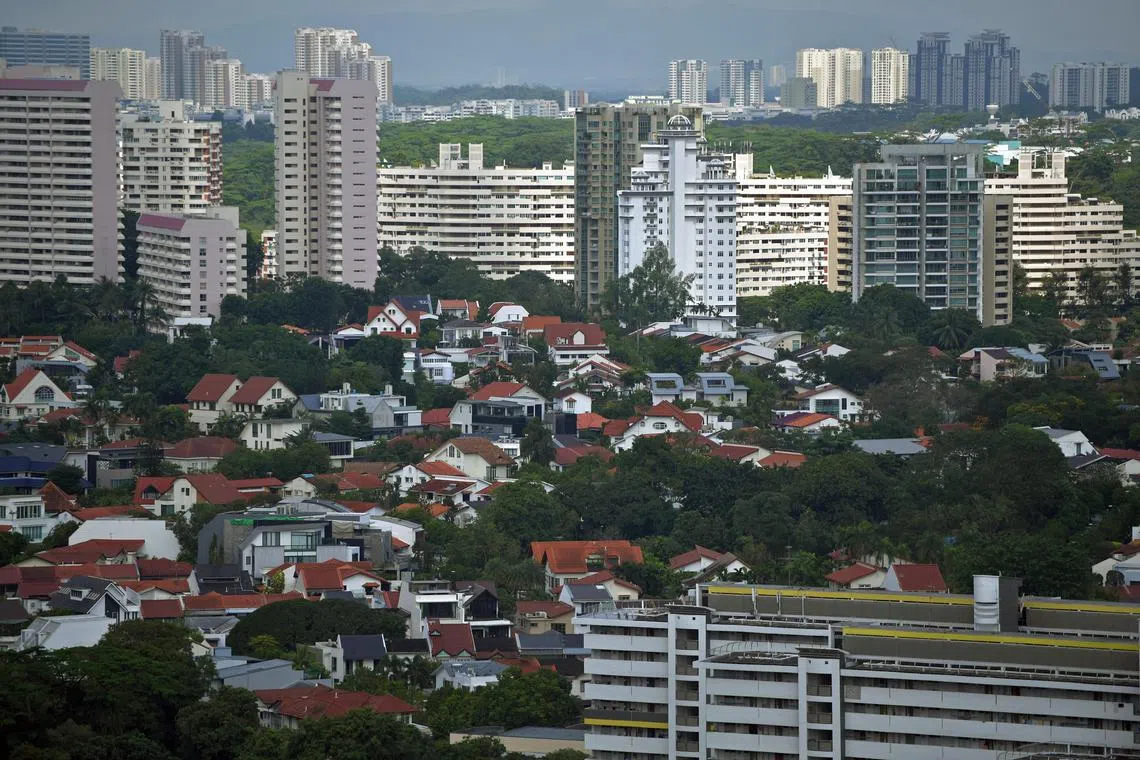 Private houses (front) with blocks of HDB housing flats in the background around Holland Road in the western part of Singapore.