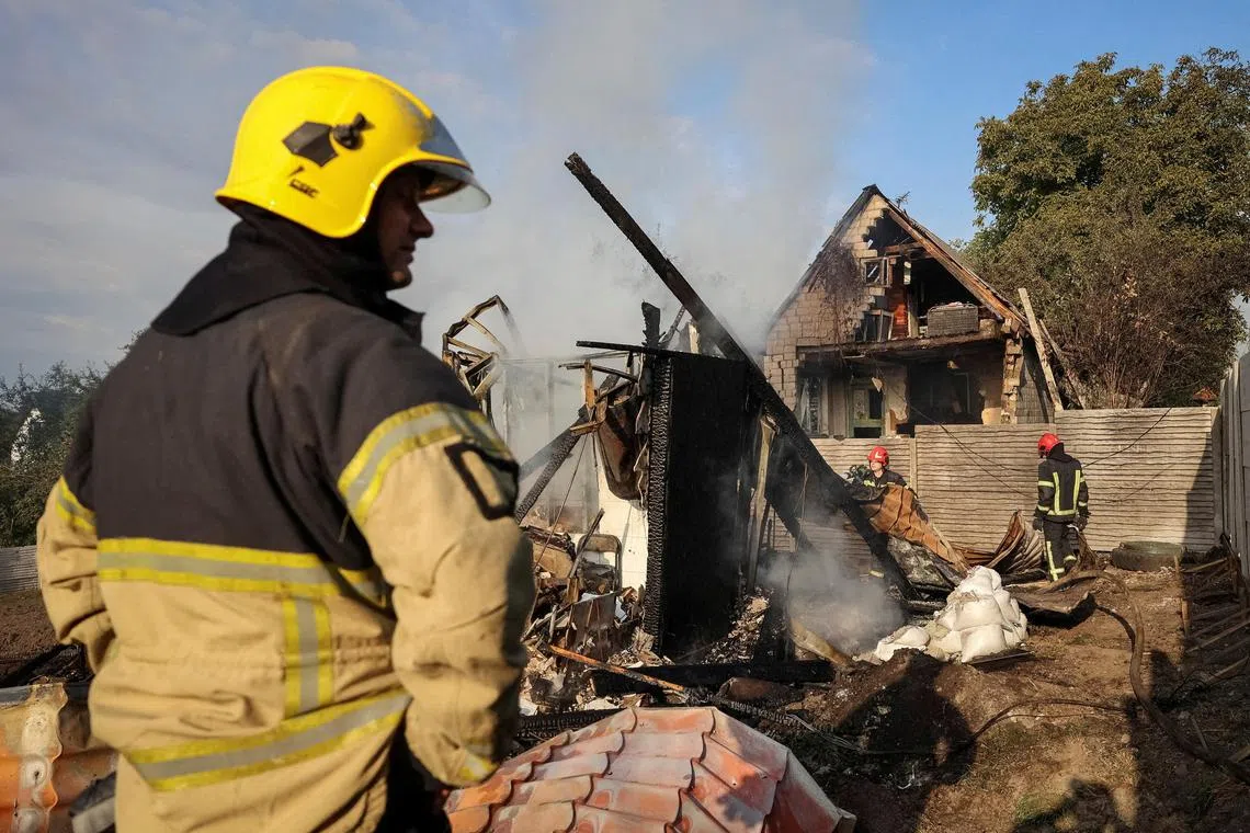 Firefighters working at the site of a Russian missile strike in a village on the outskirts of Lviv, Ukraine, on Aug 21.