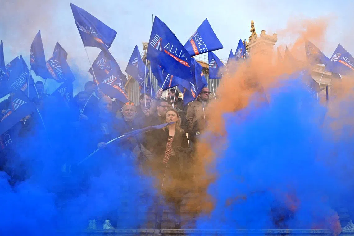 Protesters light flares and wave flags of the French police union "Alliance" during a rally called by French police unions to obtain "exceptional measures" in compensation for their compulsory presence at the Paris 2024 Olympic Games in Marseille on Jan 18.