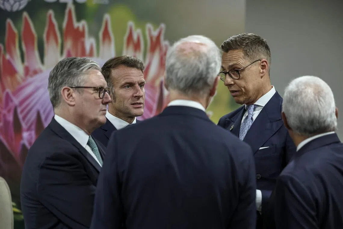 British Prime Minister Keir Starmer (left), French President Emmanuel Macron (second left) and Finnish President Alexander Stubb (second from right) talking on the sidelines of the G-20 Leaders' Summit in Johannesburg, on Nov 22.